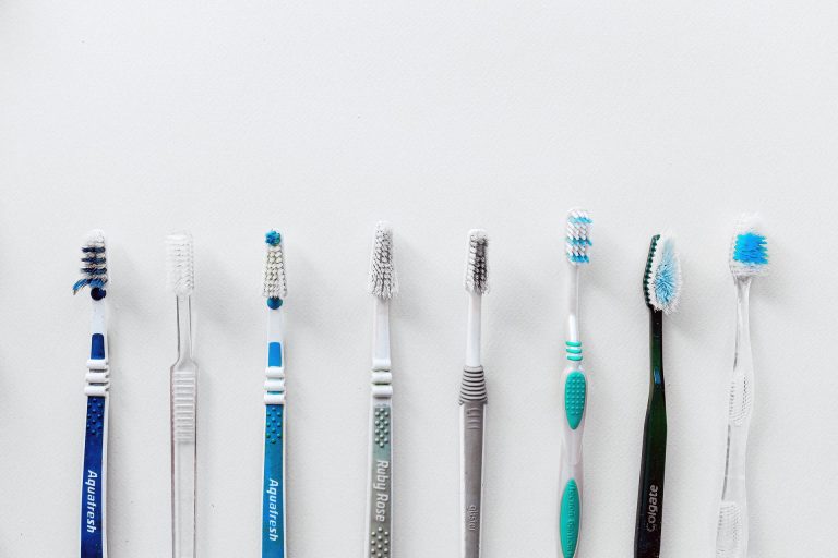 Assorted toothbrushes lined up beside each other.